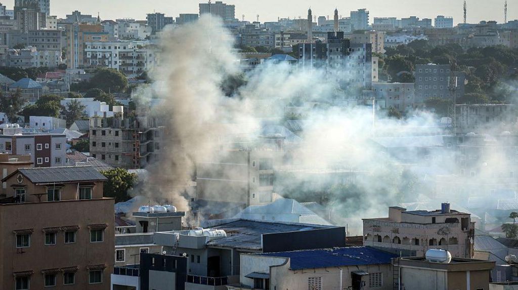 Smoke rises over buildings in a residential area in Mogadishu