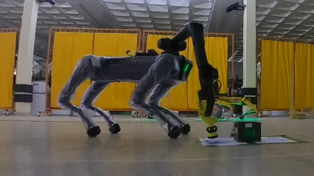 Spot, the robot, swabbing a piece of paper covered in blue chalk during a trial.