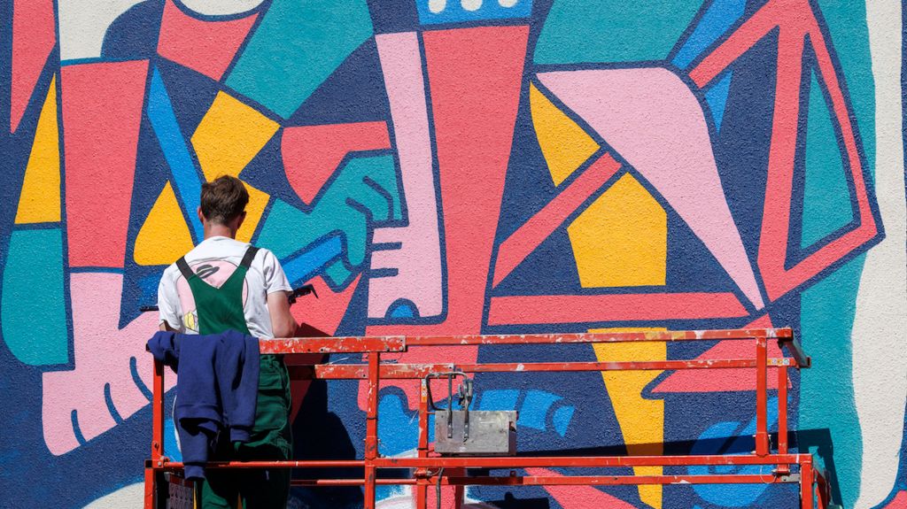 Street artist painting a mural