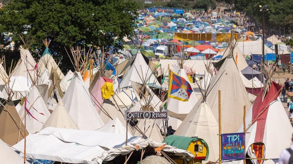 Tipis in front of tents