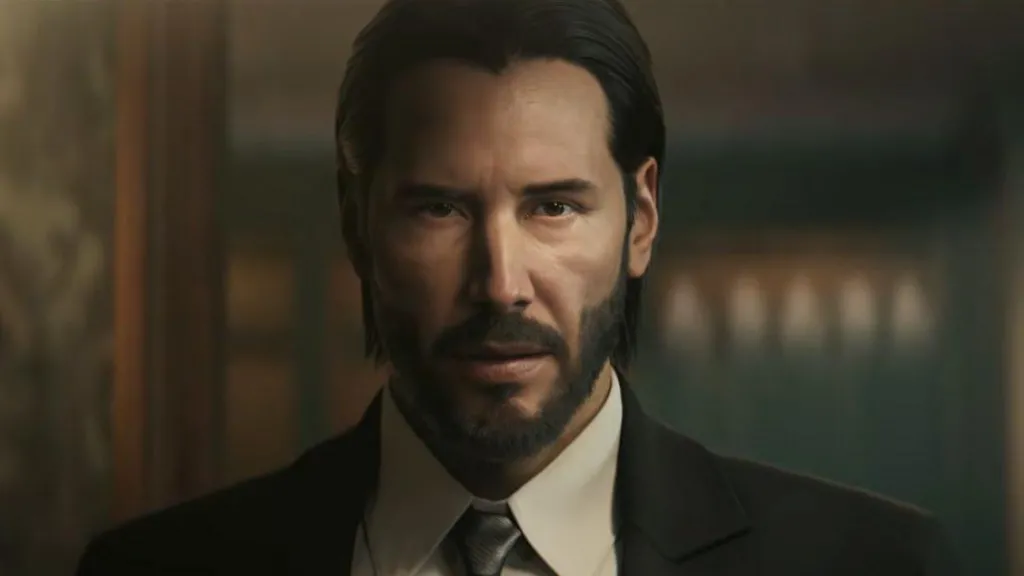 An in-game screenshot of a video game version of Keanu Reeves as the character John Wick. He is wearing a suit and looking at the camera.
