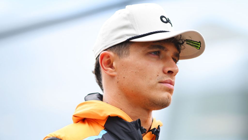 Lando Norris looks connected sternly while wearing a cap