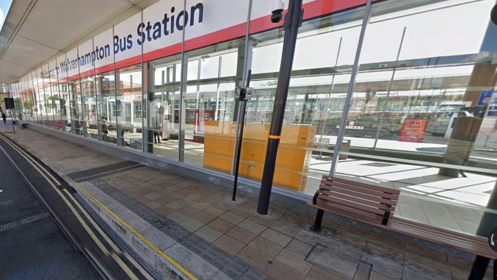 Welcome to Wolverhampton Bus Station sign above glass windows with sun streaming through them 