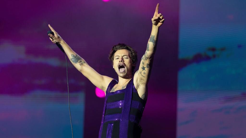 Harry Styles raises his hands to the air during a performance at Radio 1's Big Weekend in 2022