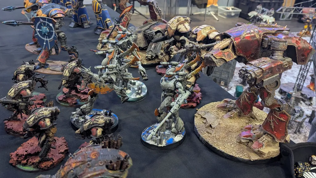 A tabletop with several painted Warhammer figures.