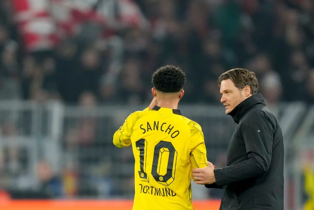 Jadon Sancho receives instructions from Dortmund coach Edin Terzic on the touchline