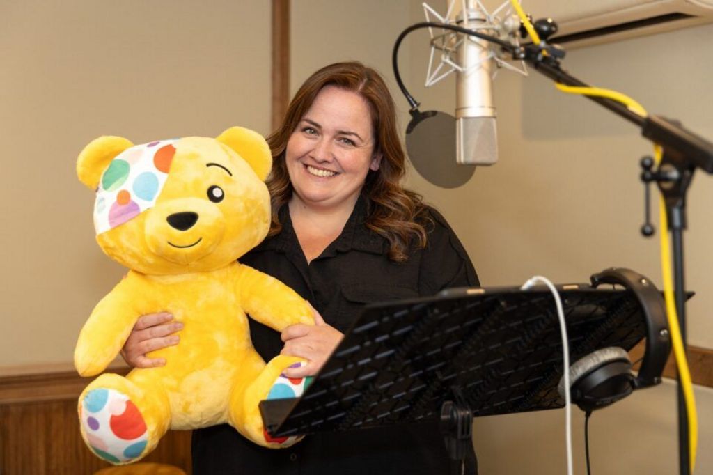 Jessica Gunning with Pudsey Bear in a recording studio.