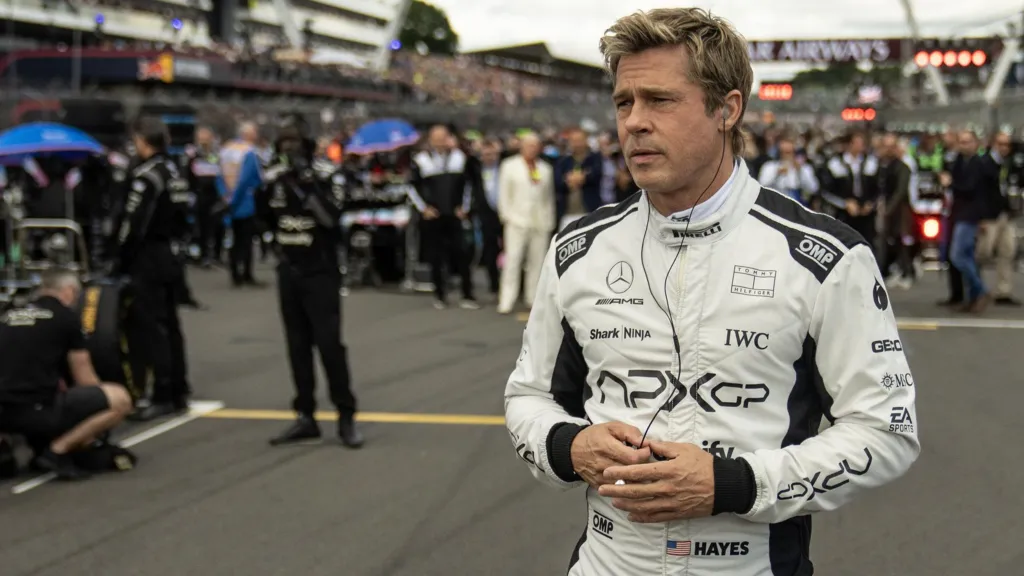 Brad Pitt in F1, standing on a race track