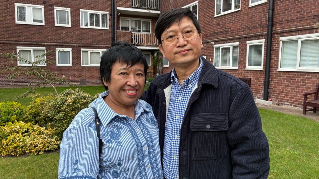 Su Su Myat and Justin King standing outside the block of flats.
