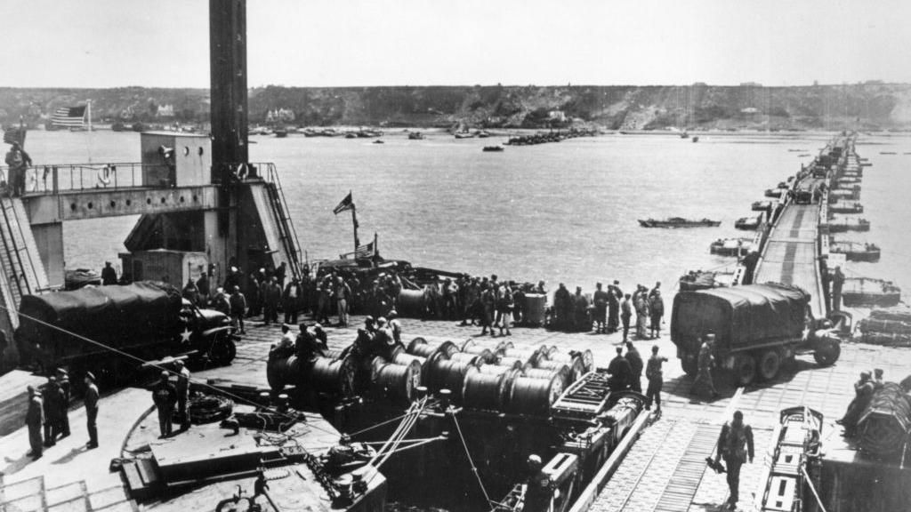 Mulberry Harbour in place, with piers and roadways showing vehicles being unloaded and driven