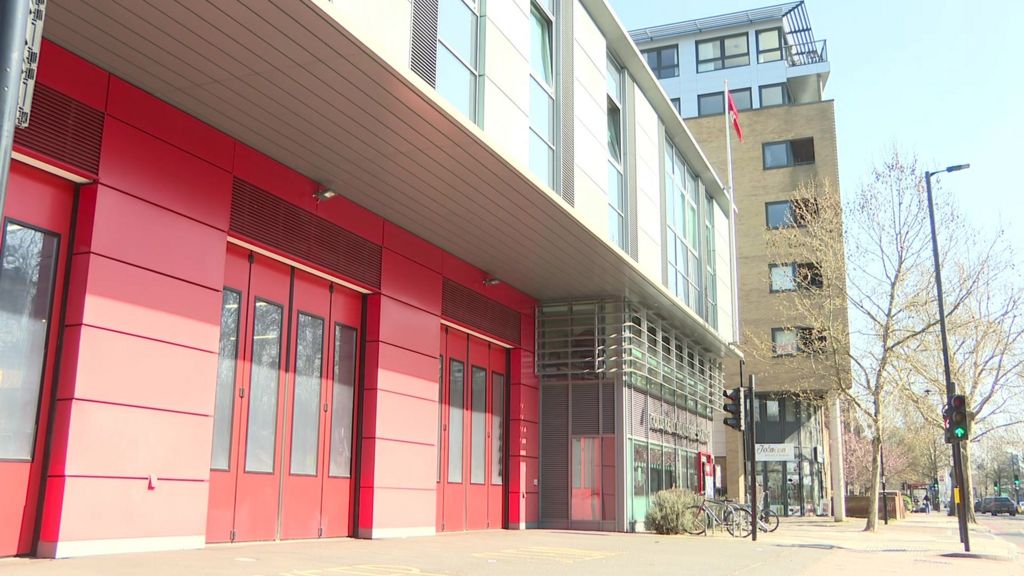 Old Kent Road fire station red doors next to sandy coloured block of flats