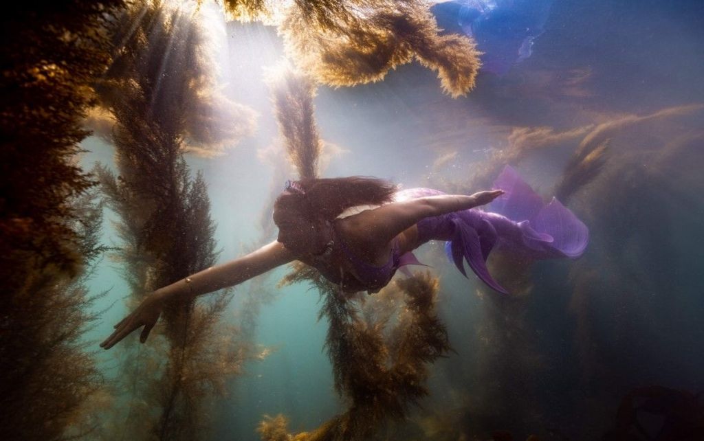 Emily-Sian Barker under water wearing a mermaid tail
