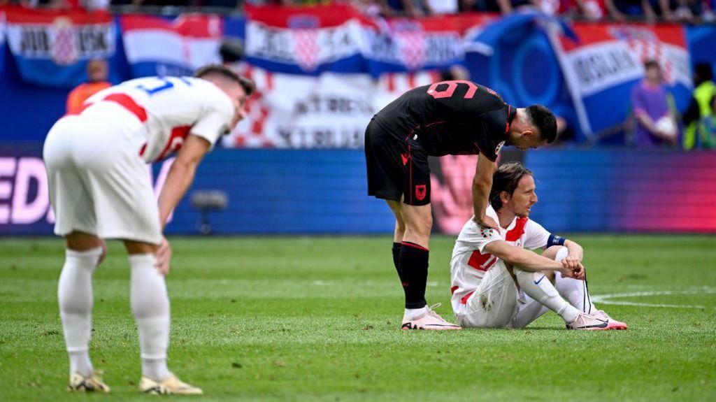 Luka Modric is consoled after Albania score a dramatic late equaliser against Croatia 
