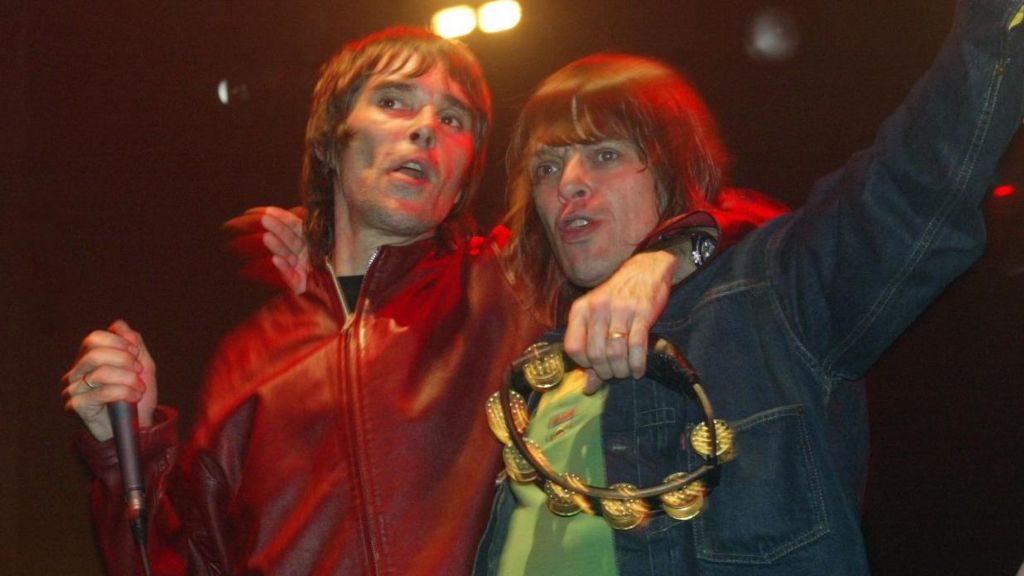Ian Brown and Mani with their arms around each other on stage in 2004