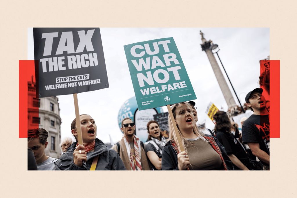 Anti-austerity campaigners carry placards as they march from Portland Place to Whitehall
