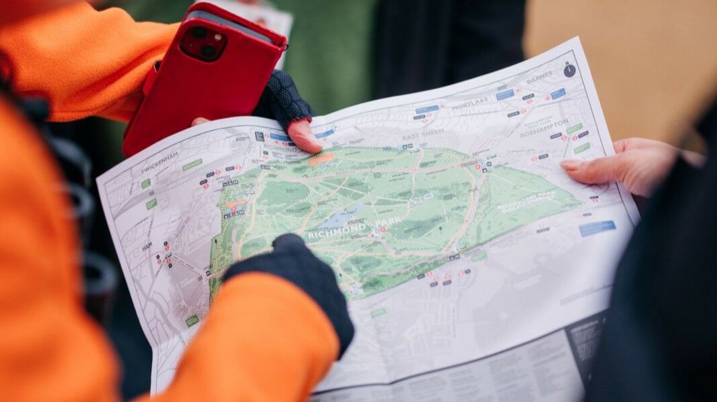 A map of Richmond Park in the hands of a volunteer ranger