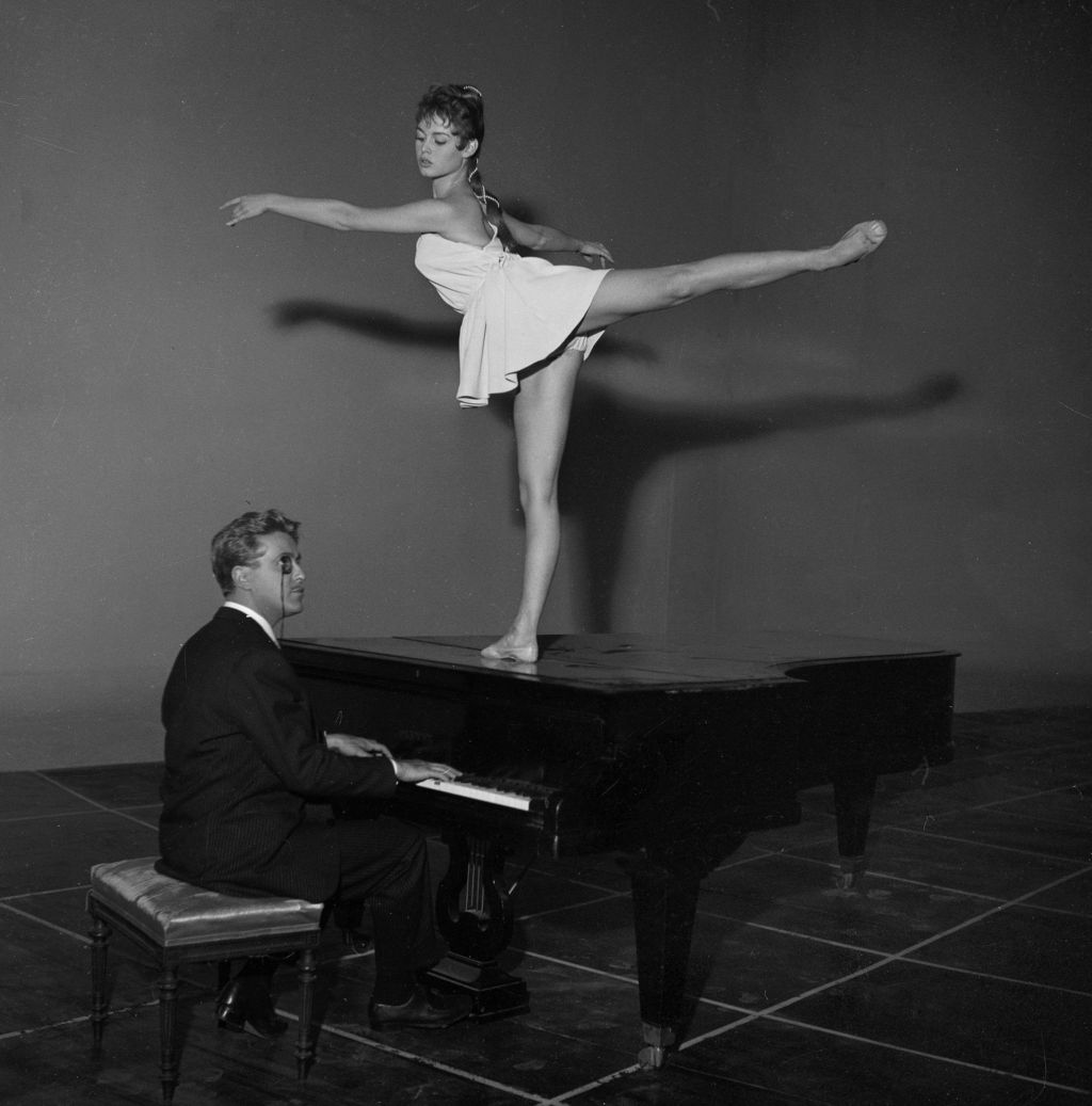 Brigitte Bardot, French actress dancing on a piano, circa 1964