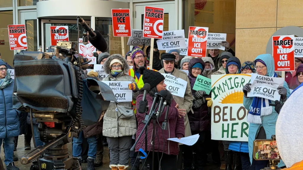 Protesters gather outside Target's headquarters holding signs reading 