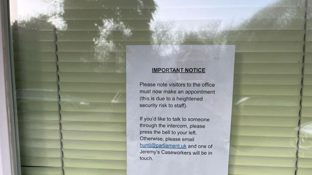 A notice on the door of Jeremy Hunt's Surrey office