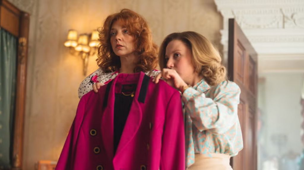 Natalie Dormer as the then Duchess of York with Mia McKenna-Bruce as her dresser Jane Andrews, looking at a jacket