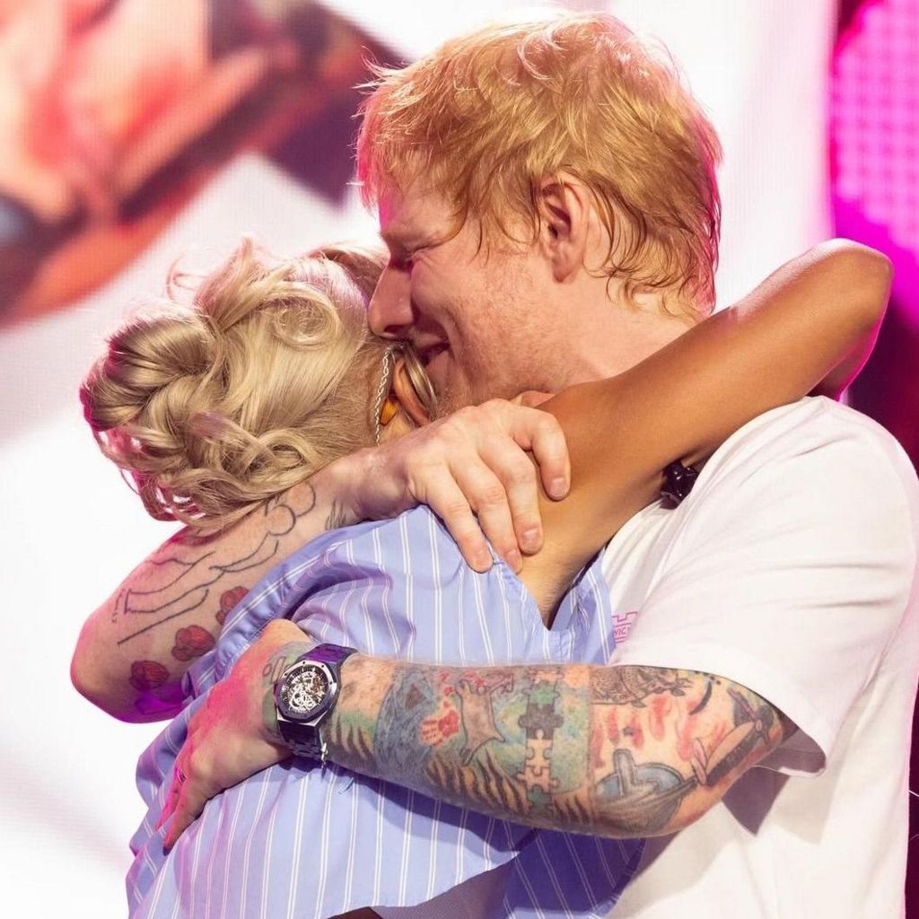 Skye Newman embracing Ed Sheeran on stage at his homecoming gig in Ipswich