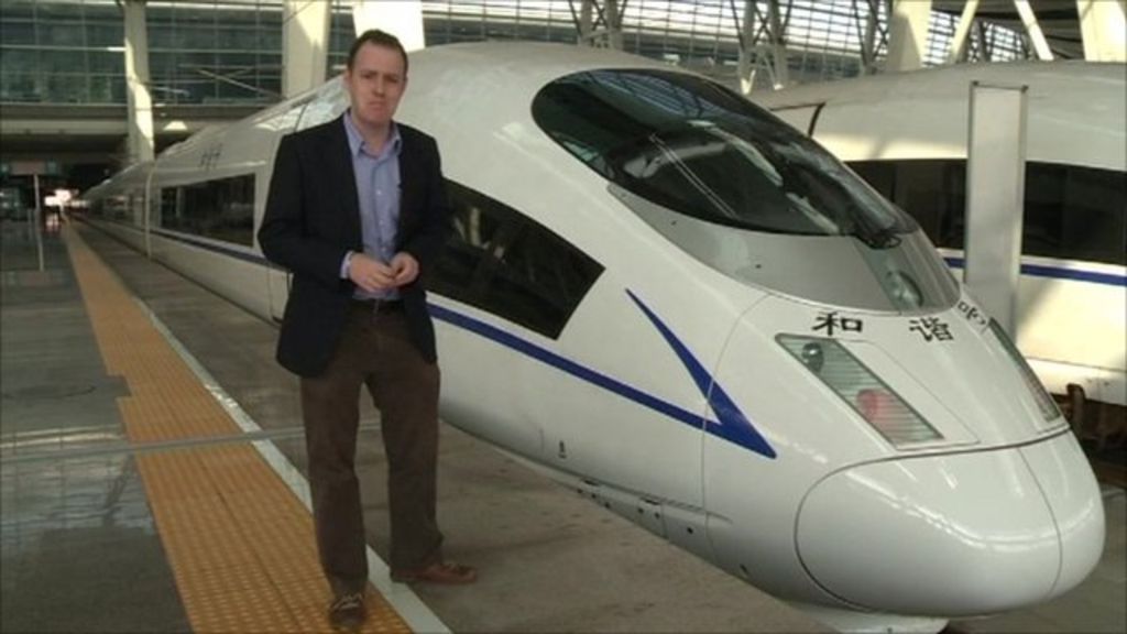 A conductor stands in a new high-speed train before it departs from the Beijing-South railway station for Shanghai as part of an official trip for members of the media June 27, 2011