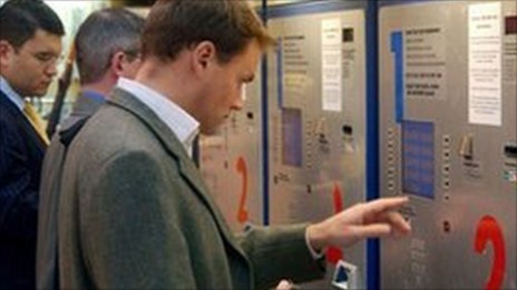 Passengers using a rail ticket machine