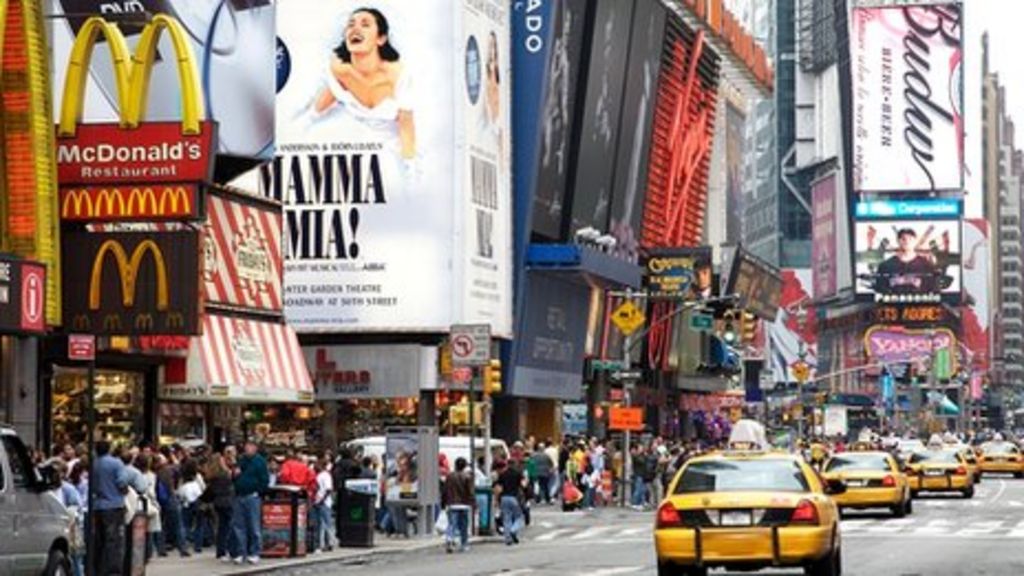 Many people live in the city. Outdoor advertising New York.