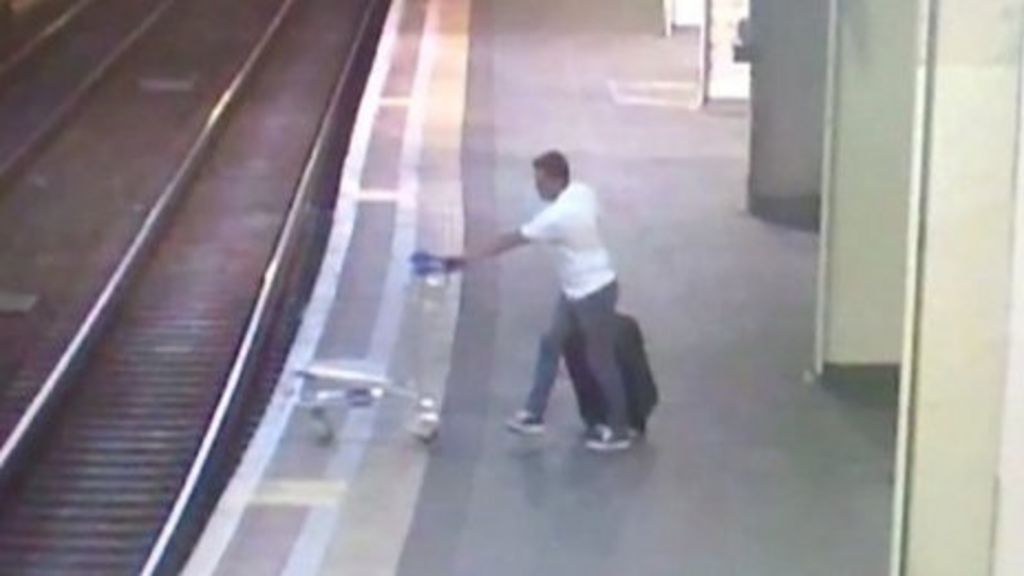 CCTV shows man pushing trolley on to Euston railway tracks - BBC News