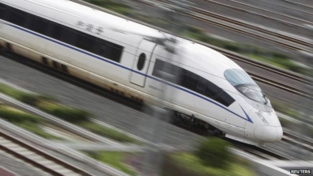A high-speed train travels on the railway to Beijing in Nanning, southern China's Guangxi province on 13 June, 2014