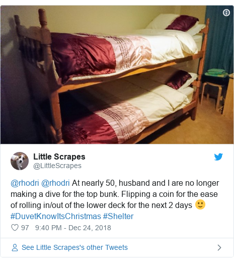 Twitter post by @LittleScrapes: @rhodri @rhodri At nearly 50, husband and I are no longer making a dive for the top bunk. Flipping a coin for the ease of rolling in/out of the lower deck for the next 2 days 🙂 #DuvetKnowItsChristmas #Shelter 