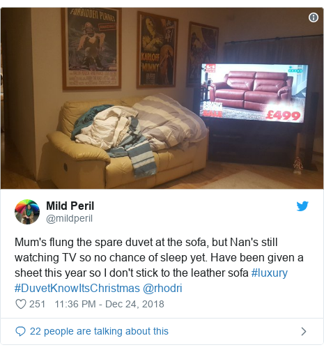 Twitter post by @mildperil: Mum's flung the spare duvet at the sofa, but Nan's still watching TV so no chance of sleep yet. Have been given a sheet this year so I don't stick to the leather sofa #luxury #DuvetKnowItsChristmas @rhodri 