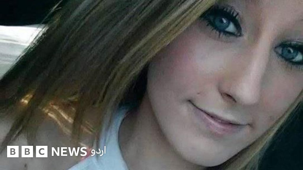 Chelsea Yasser smiles slightly at the camera, her blond hair falling to her chin and shoulders and her eyes made up with heavy mascara and liner