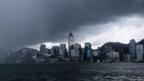 A view of a city skyline with rain clouds overhead