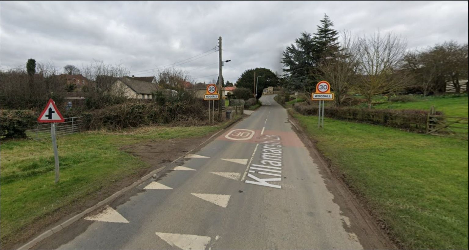 Road and speed limit signs at entrance to the village of Woodall in Rotherham