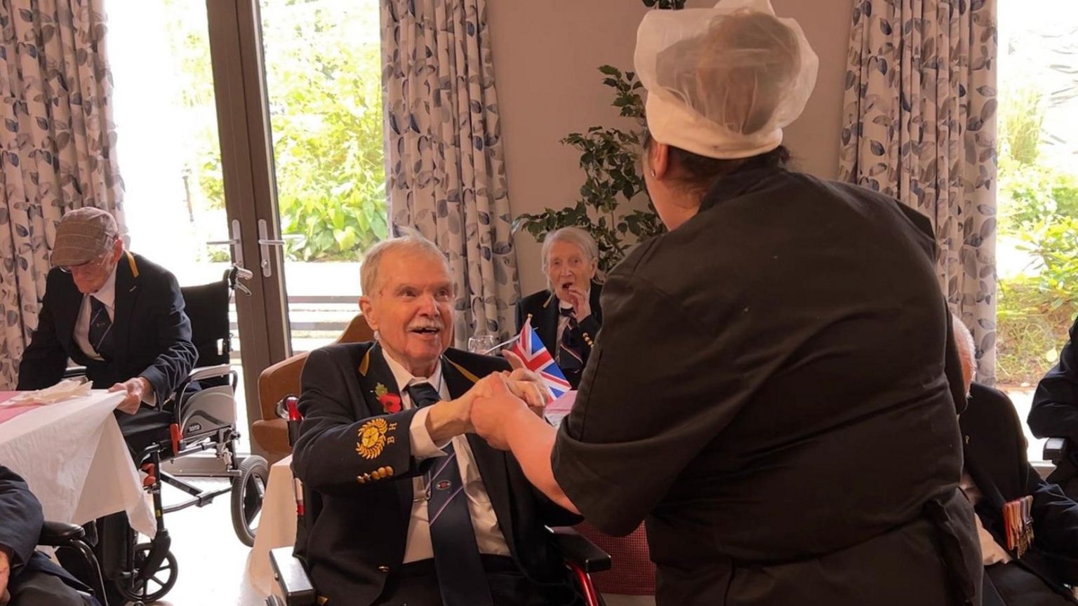 Veterans and care home staff at an event