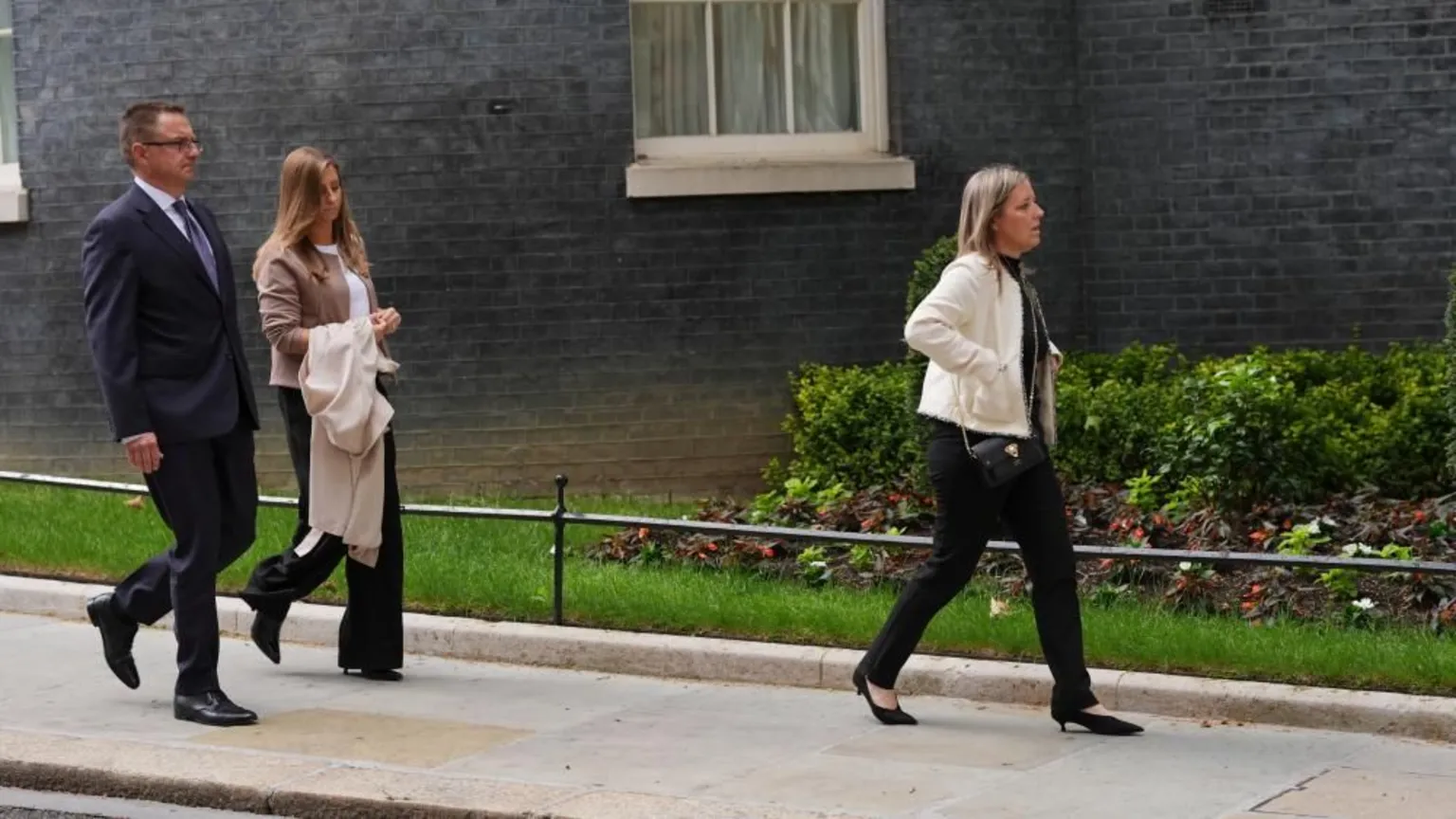 PA Media Henry Nowak's father and stepmother walk with his mother a few steps ahead