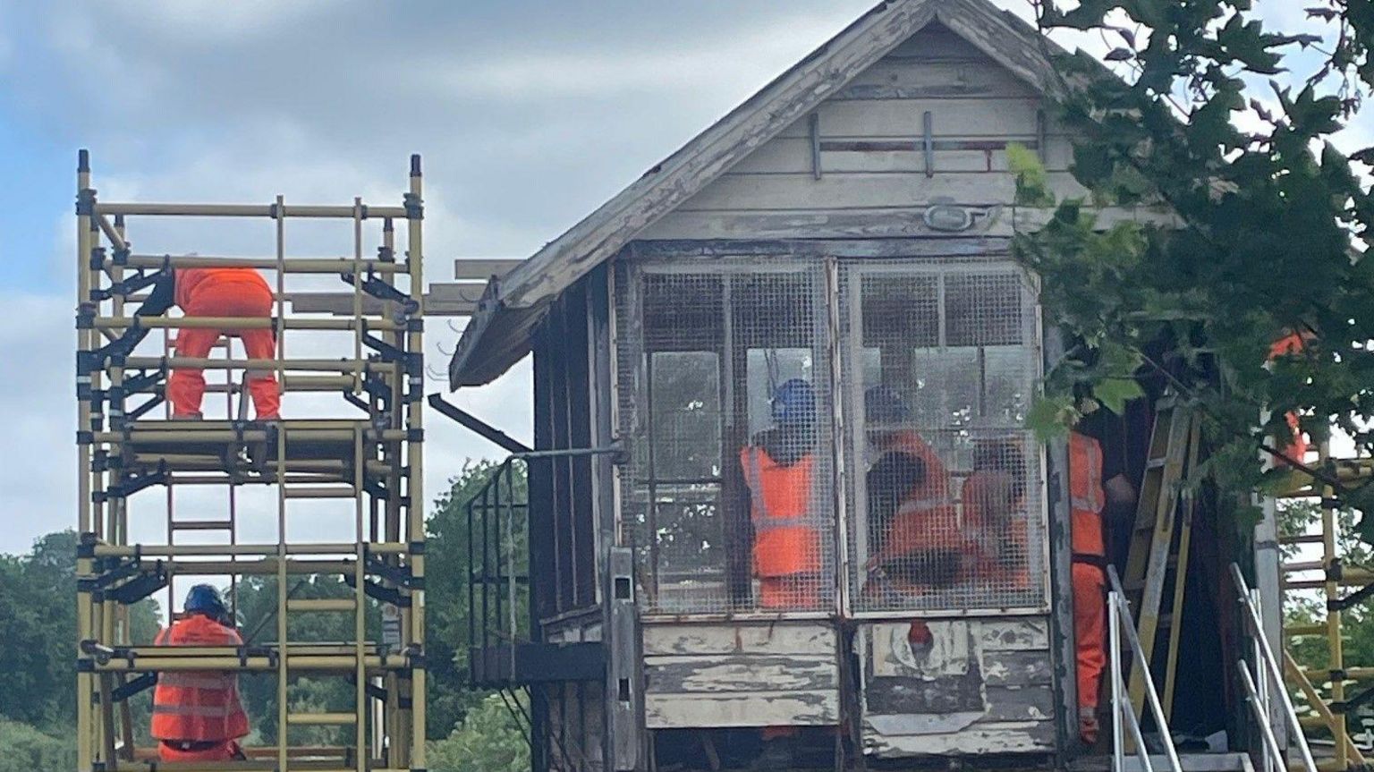 Network Rail engineers stripping out the roof of the signal box in Wye.