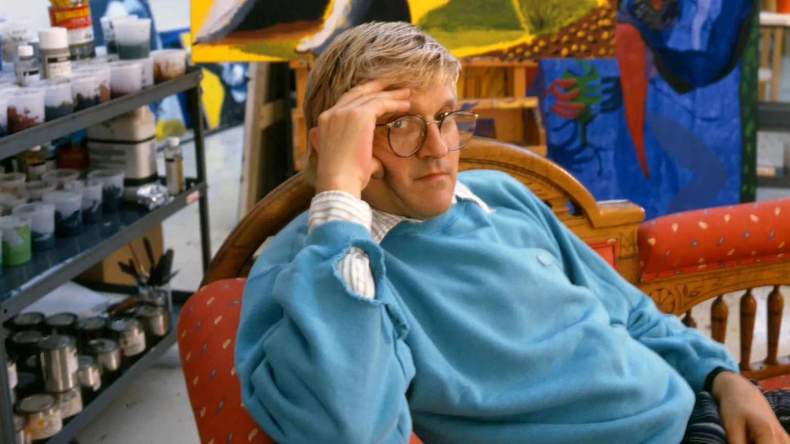 Getty Images David Hockney in his Studio in California in 1987 wearing a blue jumper relaxing on a chair with his hand to his face