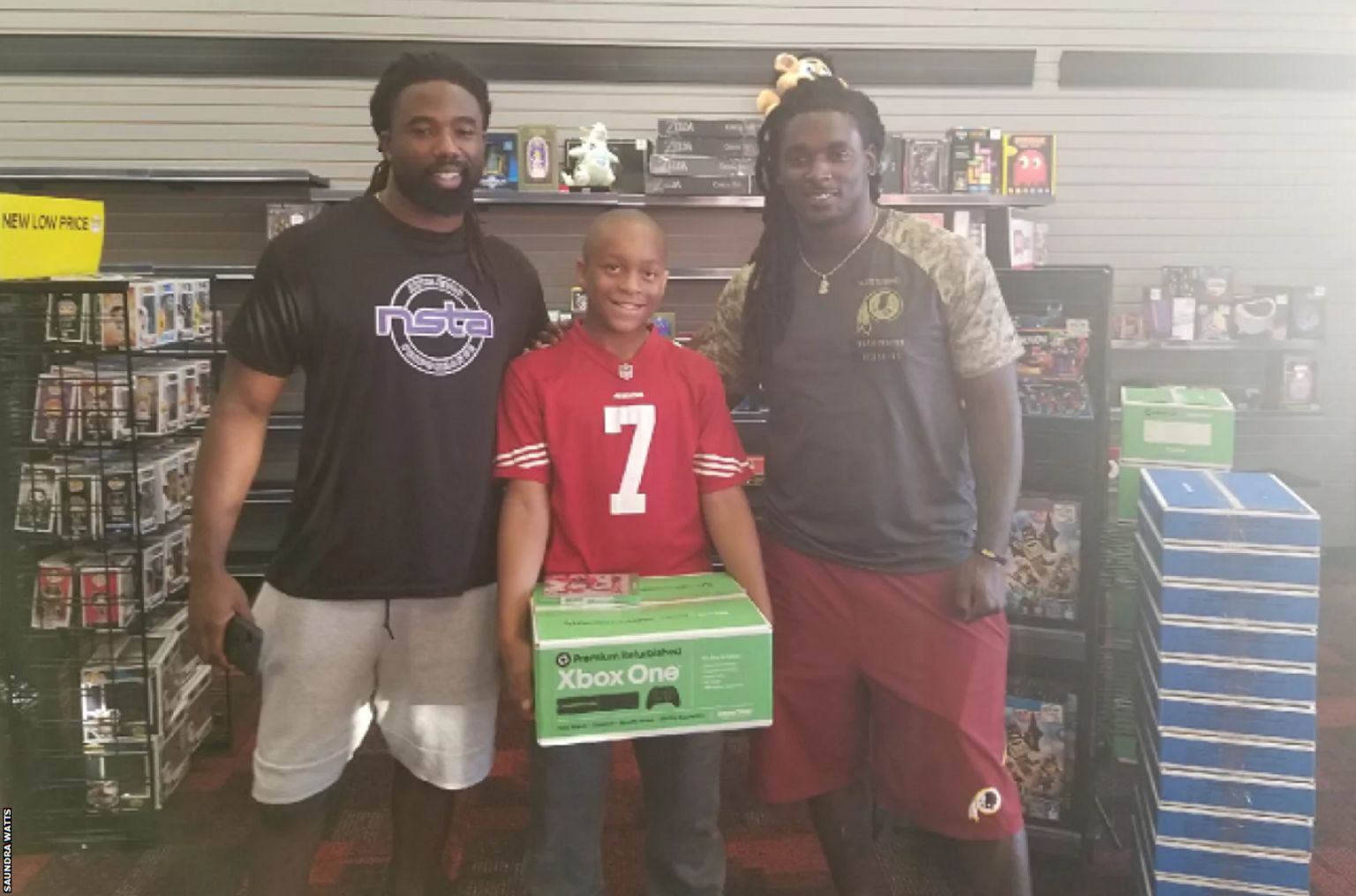 Jaden Watts receives his Xbox from two NFL players