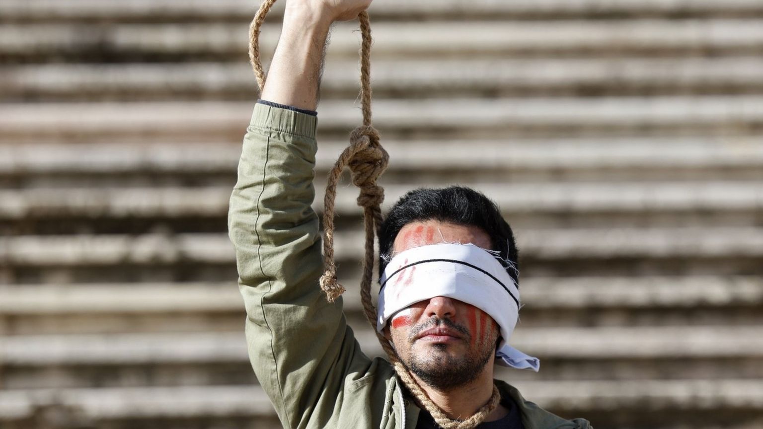 An Iranian-Portuguese man protests against the executions of two Iranian man in connection with the anti-government protests in Iran, in Lisbon, Portugal (16 December 2022)
