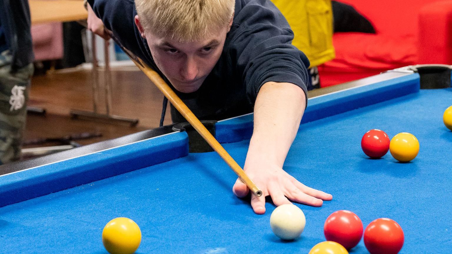 A child playing pool with the Ourside charity in Worcester 