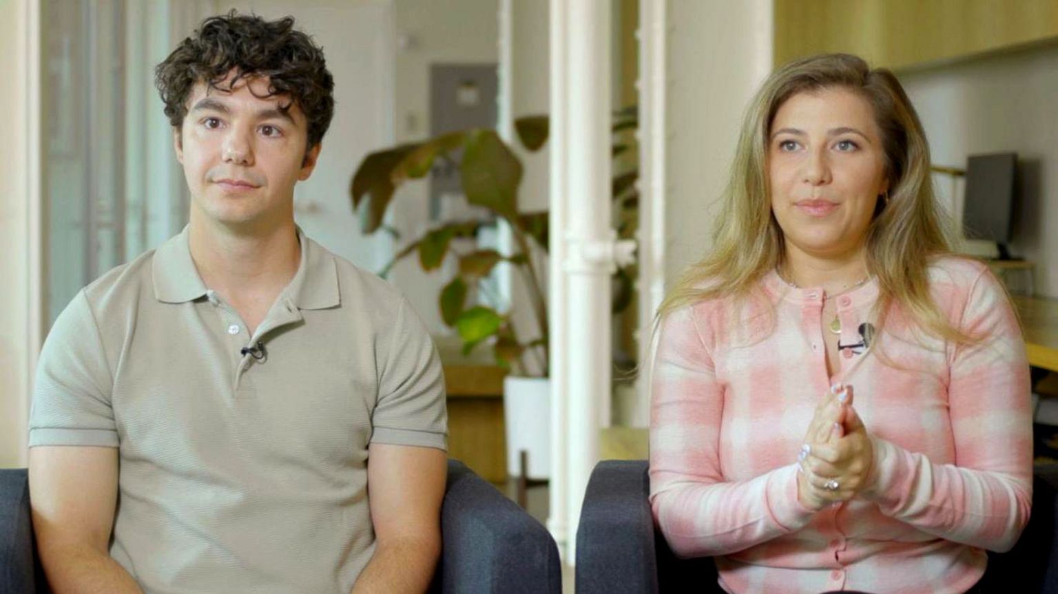 Paul Skye Lehrman and Linnea Sage, who claim their voices were stolen, sit in armchairs with neutral expressions.