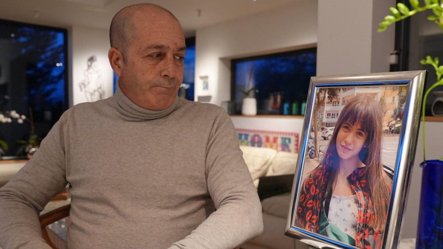 Mario Janin, Mia's dad, looks at an image of his daughter