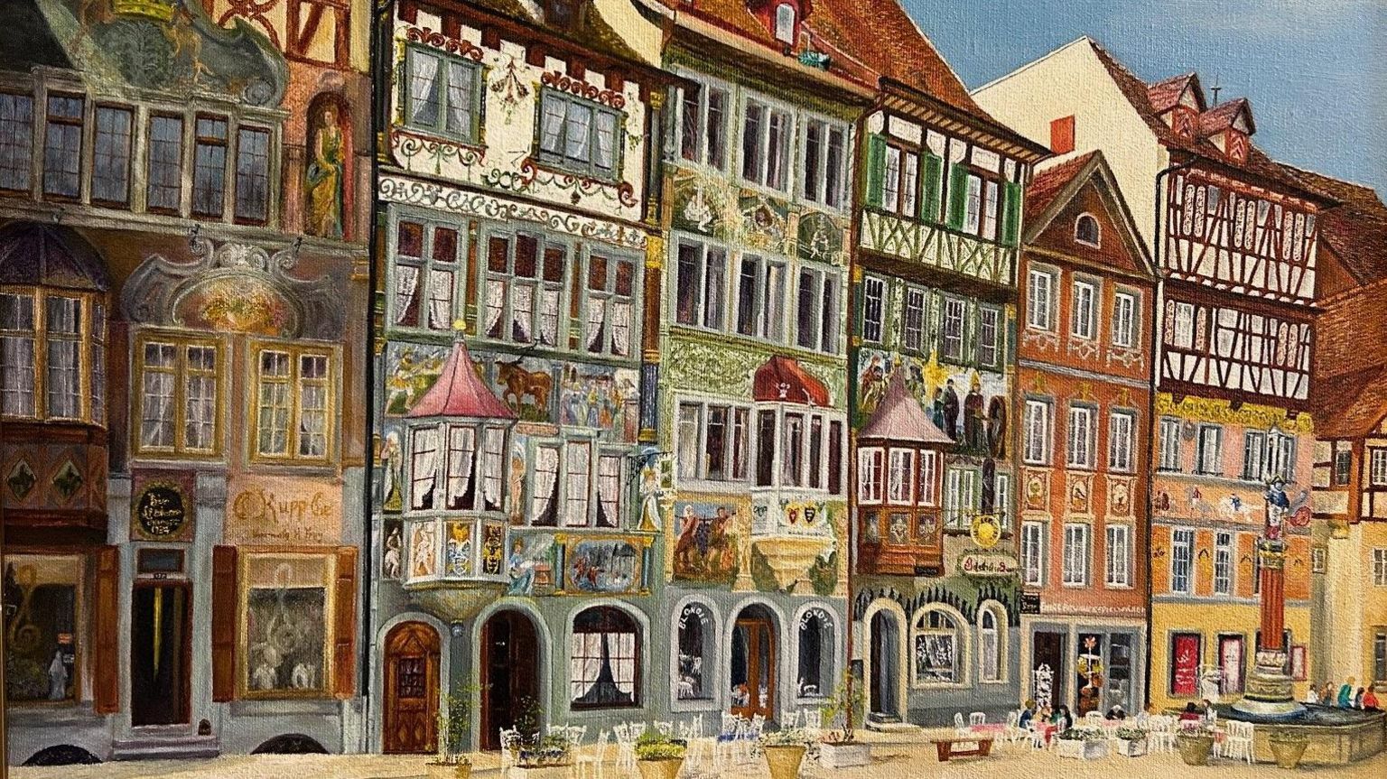 A painting of a traditional town in Switzerland with painted housing