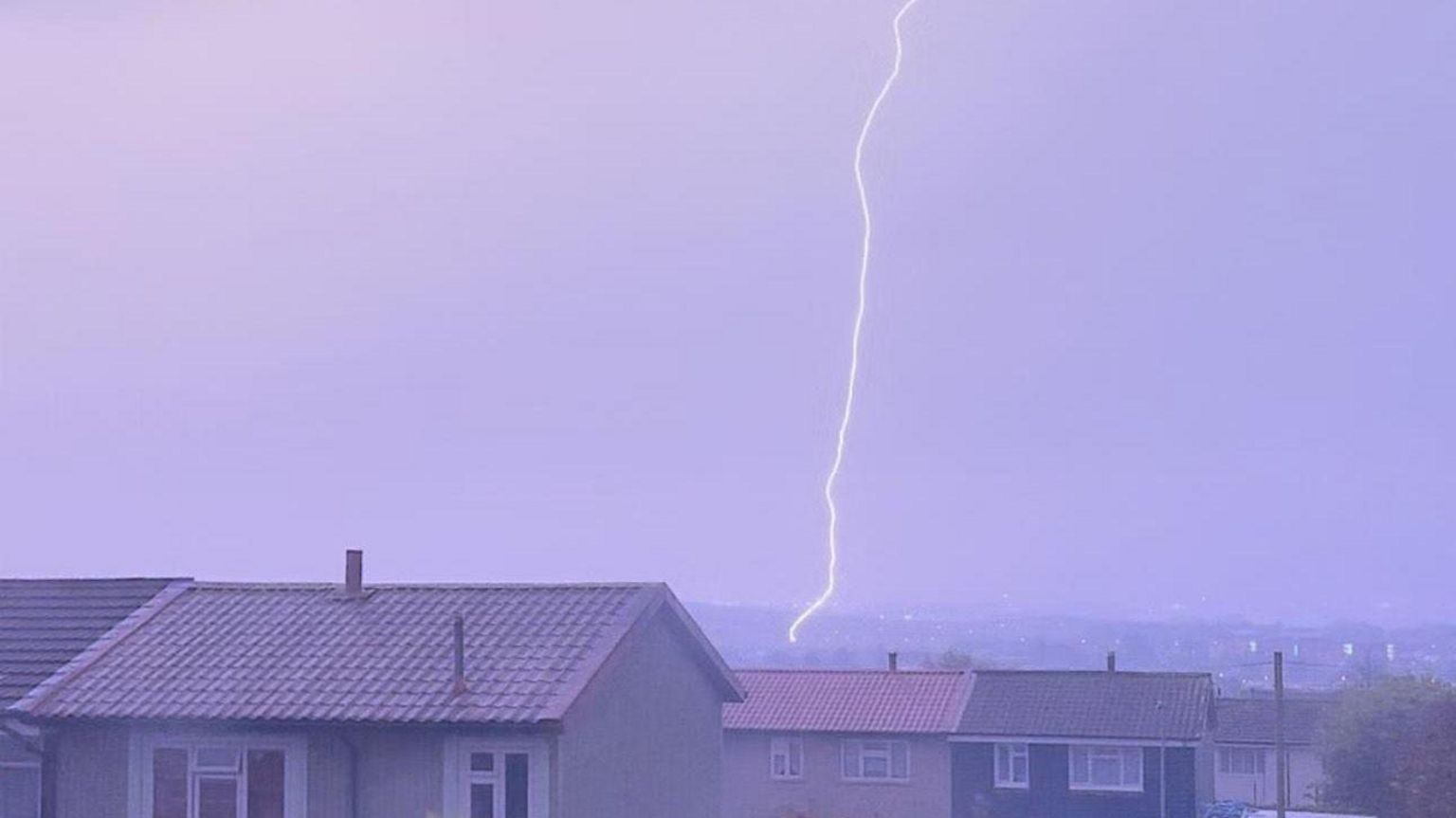 A vertical lightning strike crashes down above houses in Portsmouth