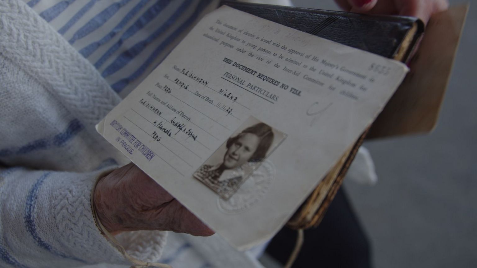 Lady Milena Grenfell-Baines holds her identity document