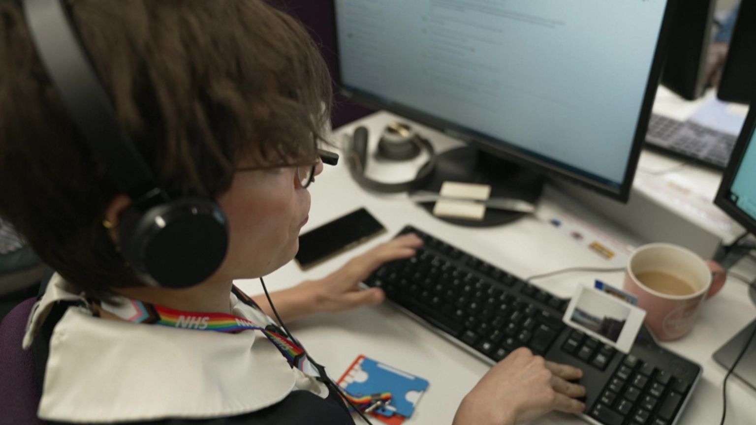 One of the trained counsellors, Chris, wearing a headset at her computer