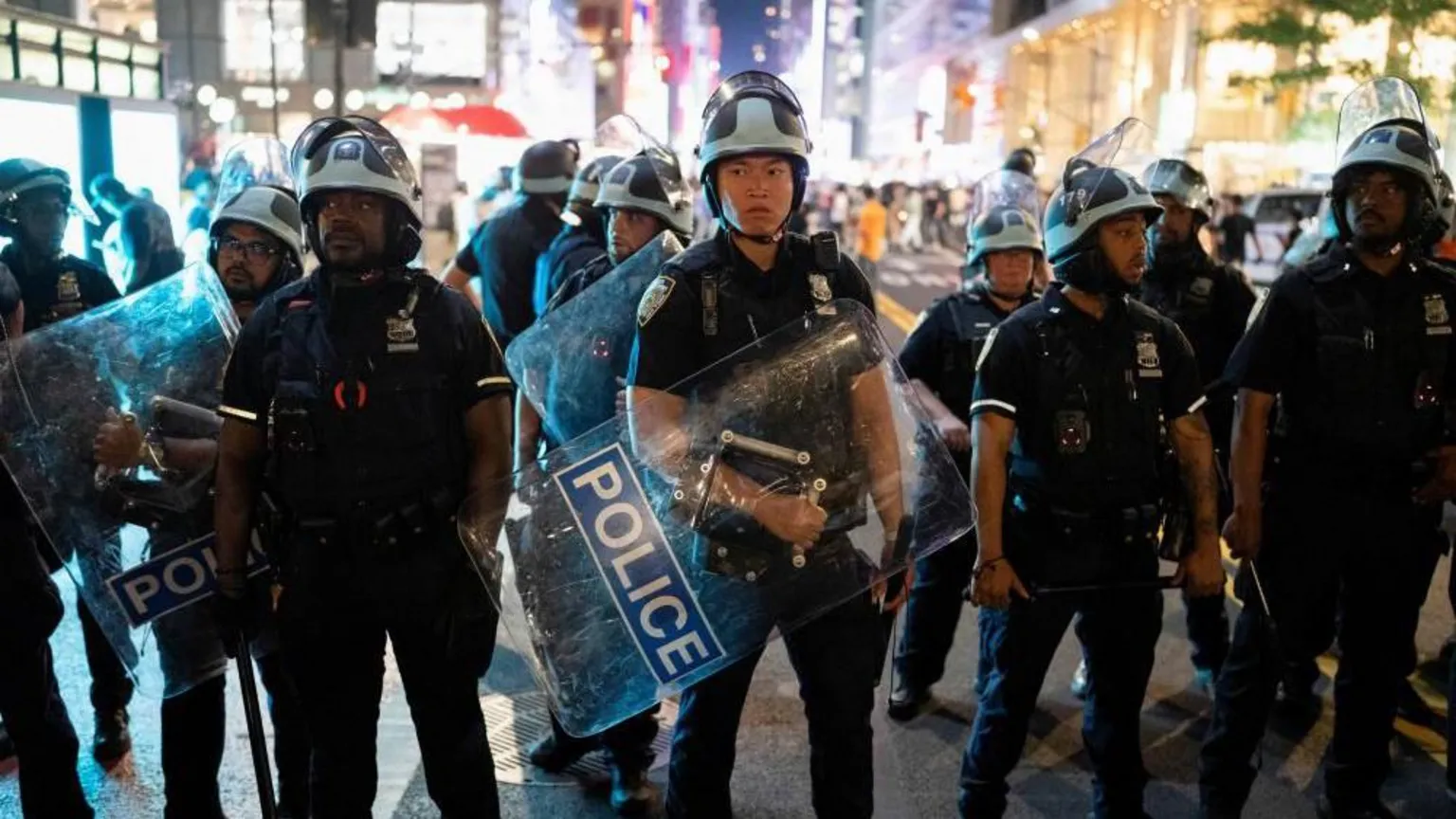 Reuters A group of police officers wearing helmets and holding shields prepare to disperse a crowd in Bryant Park, New York City.