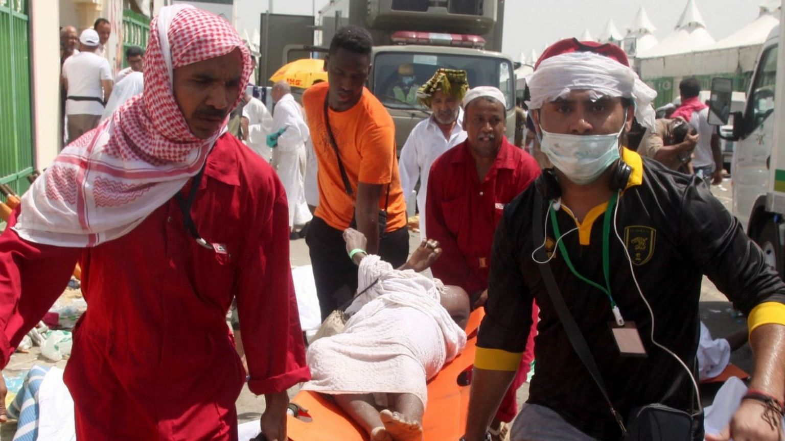 Saudi emergency personnel and pilgrims carry a wounded person at Mina on 24 September 2015